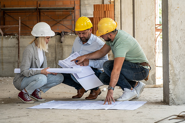 A female architect and a focused construction managers engage